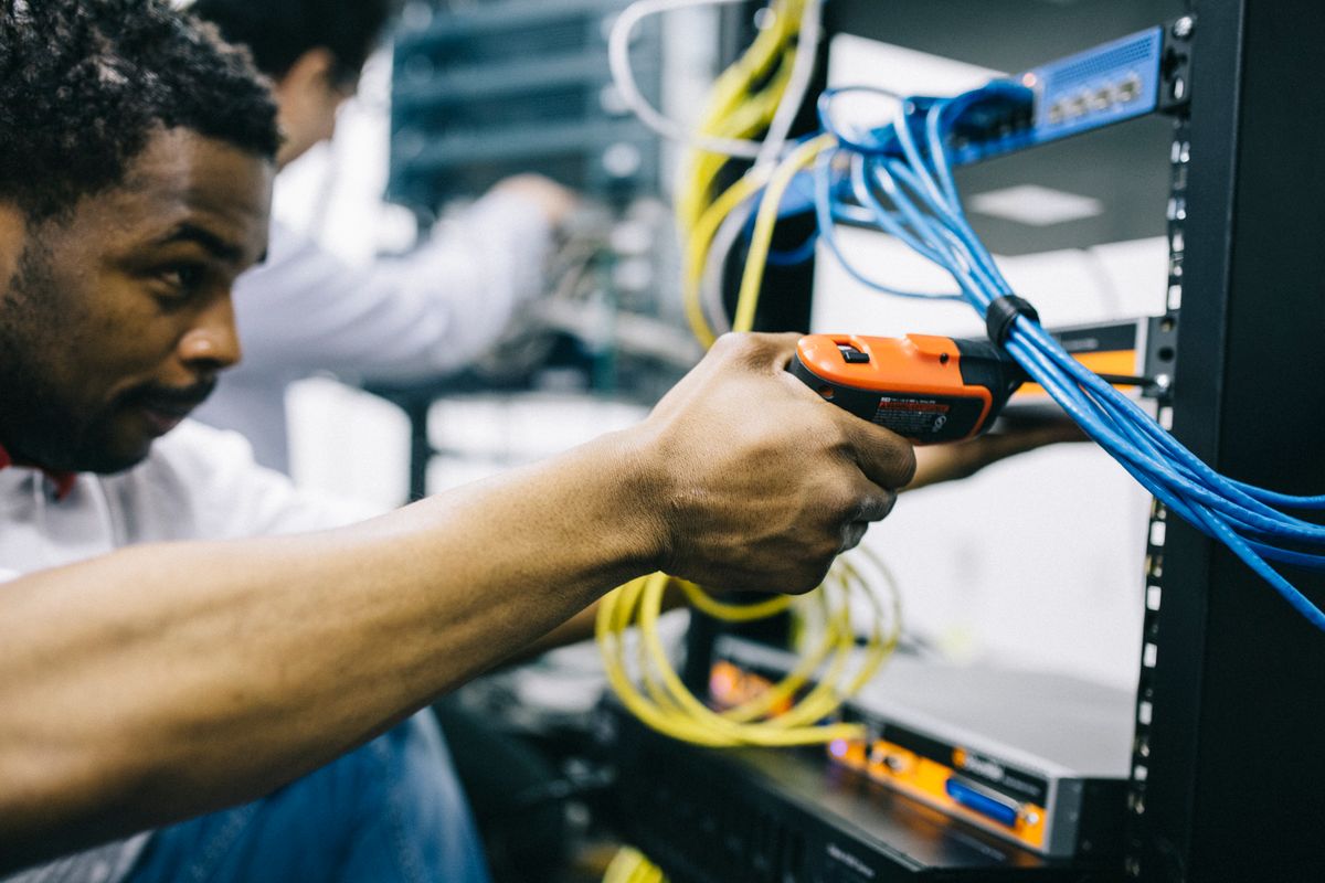 A technician working with network cables
